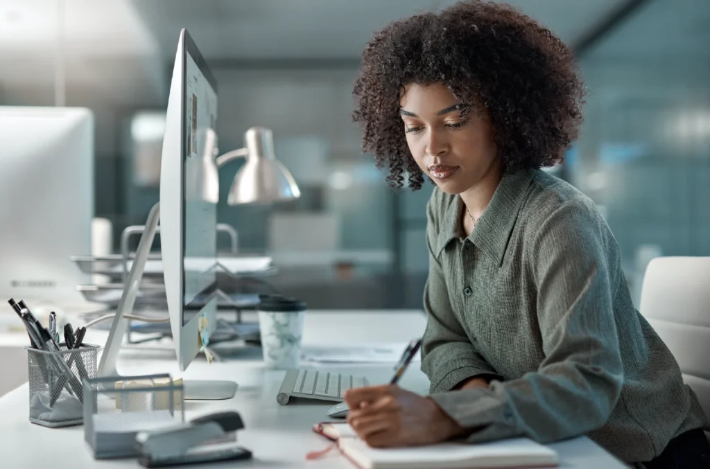African business woman working at a desk - no leader is an island